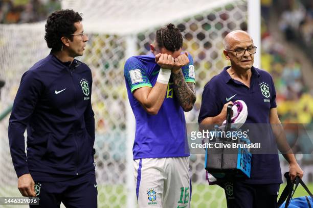 Alex Telles of Brazil receives medical treatment during the FIFA World Cup Qatar 2022 Group G match between Cameroon and Brazil at Lusail Stadium on...