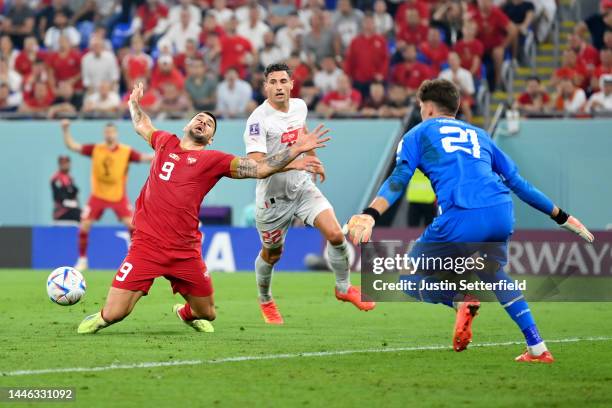 Aleksandar Mitrovic of Serbia battles for possession with Fabian Schaer of Switzerland during the FIFA World Cup Qatar 2022 Group G match between...