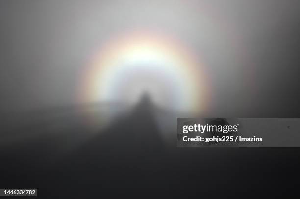 brocken specter, a meteorological phenomenon called brocken specter - brockengespenst stock-fotos und bilder