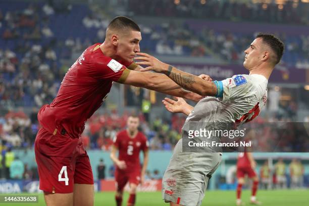 Granit Xhaka of Switzerland and Nikola Milenkovic of Serbia square off during the FIFA World Cup Qatar 2022 Group G match between Serbia and...