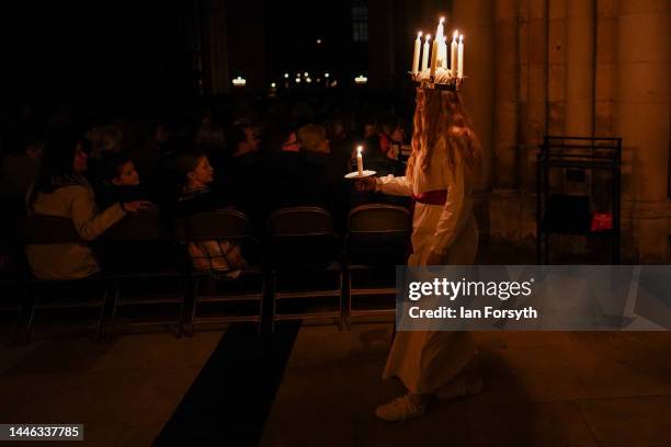 Clara Nordin originally from Gothenburg, plays the role of Lucia as she leads the procession during the Swedish Sankta Lucia festival of Light...