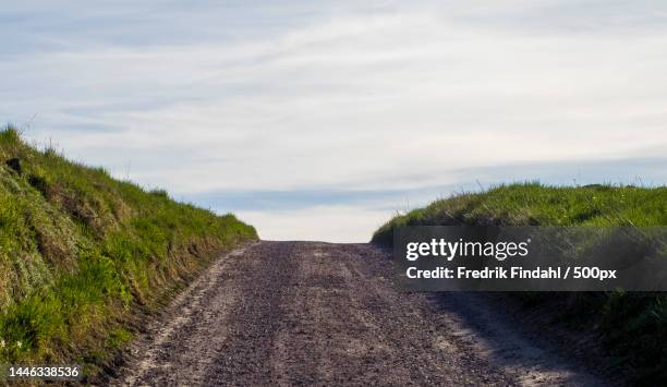 empty road amidst field against sky,sweden - vår stock pictures, royalty-free photos & images