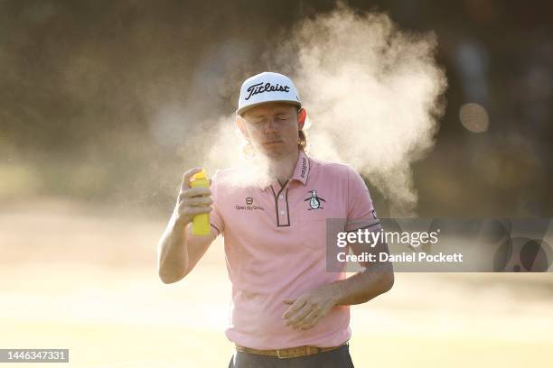 Cameron Smith of Australia sprays insect repellent during Day 3 of the 2022 ISPS HANDA Australian Open at Victoria Golf Club on December 03, 2022 in...