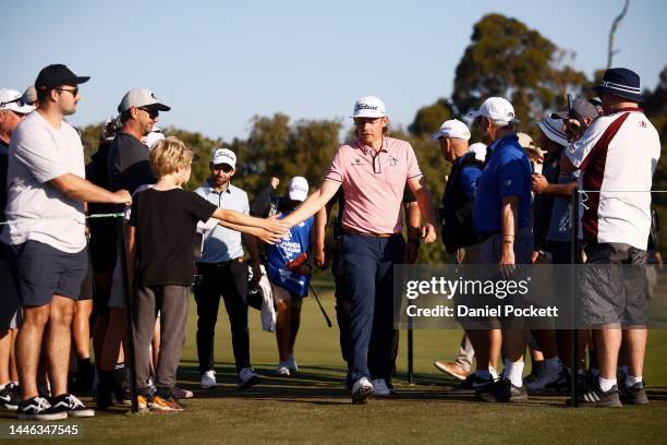 Cameron Smith of Australia high fives a young fan as he walks to the next hole during Day 3 of the 2022 ISPS HANDA Australian Open at Victoria Golf...