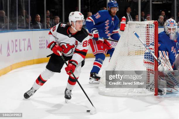 Jack Hughes of the New Jersey Devils skates with the puck against the New York Rangers at Madison Square Garden on November 28, 2022 in New York City.