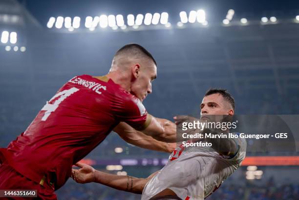 Granit Xhaka of Switzerland is attacked by Nikola Milenkovic of Serbia during the FIFA World Cup Qatar 2022 Group G match between Serbia and...