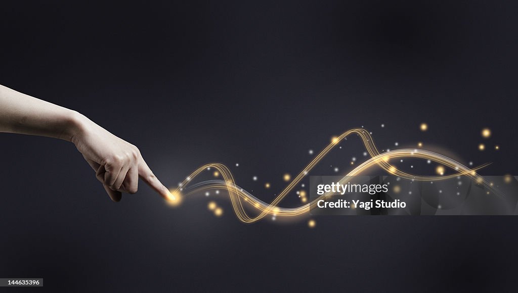 Hand with fibre optic light trail.