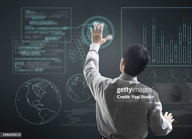 man using hi-tech computer monitor - futuristic screen stock pictures, royalty-free photos & images