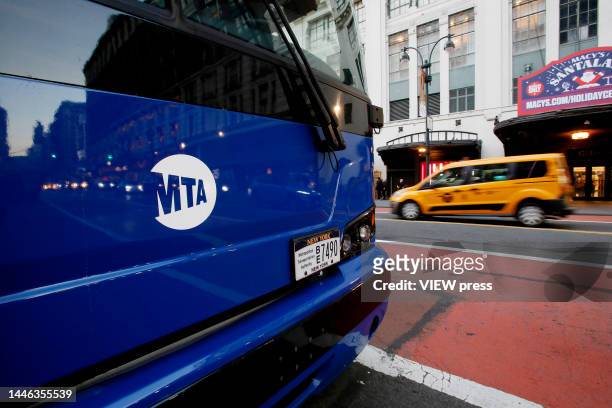 Taxi drives near an MTA bus on December 2, 2022 in New York City. NYC Metropolitan Transportation Authority has proposed a 5.5 percent fare hike next...