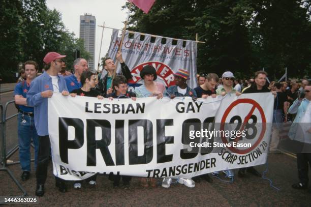 Celebrities help to hold a banner opposing Section 28, at the Lesbian, Gay, Bisexual, and Transgender Pride event, London, 4th July 1998. Those...