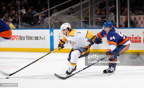 Cole Bardreau of the New York Islanders pursues Jeremy Lauzon of the Nashville Predators during the first period at the UBS Arena on December 02,...