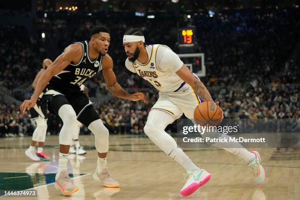 Anthony Davis of the Los Angeles Lakers dribbles the ball against Giannis Antetokounmpo of the Milwaukee Bucks during the first half of the game at...