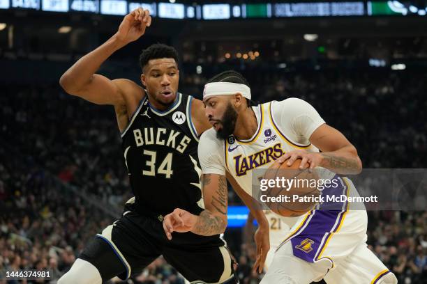 Anthony Davis of the Los Angeles Lakers dribbles the ball against Giannis Antetokounmpo of the Milwaukee Bucks during the first half of the game at...