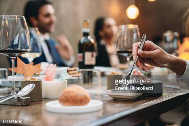 close-up shot on a hand with a fork in a restaurant - 19 years old dinner stock pictures, royalty-free photos & images