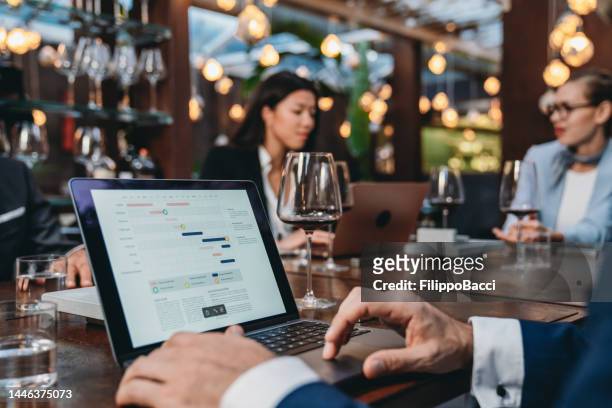 business people are working together during a meeting in a luxury restaurant - food and drink establishment stock pictures, royalty-free photos & images