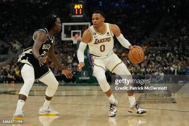 Russell Westbrook of the Los Angeles Lakers dribbles the ball against Jrue Holiday of the Milwaukee Bucks during the first half of the game at Fiserv...