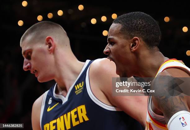 Dejounte Murray of the Atlanta Hawks reacts after a basket against Nikola Jokic of the Denver Nuggets during the second half at State Farm Arena on...