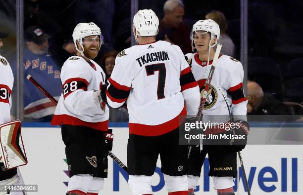 Brady Tkachuk of the Ottawa Senators celebrates with teammates Claude Giroux and Tim Stutzle after scoring the overtime game-winning goal against the...