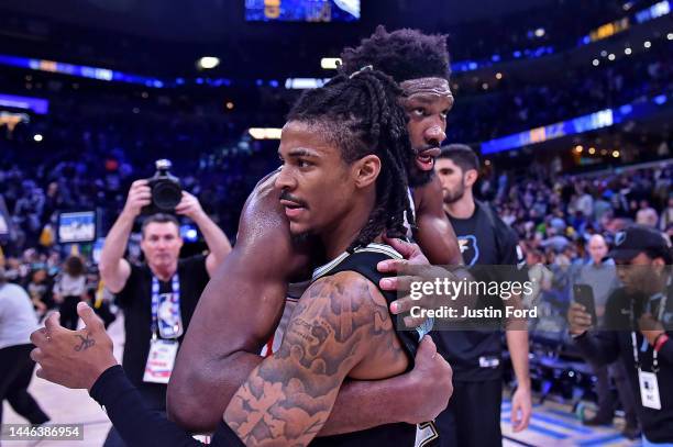 Ja Morant of the Memphis Grizzlies and Joel Embiid of the Philadelphia 76ers embrace after the game at FedExForum on December 02, 2022 in Memphis,...