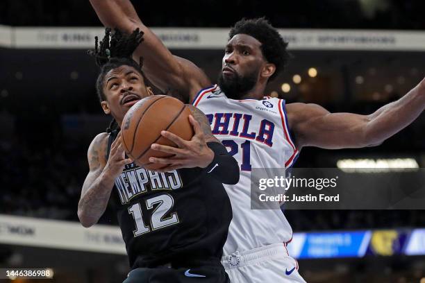 Ja Morant of the Memphis Grizzlies handles the ball against Joel Embiid of the Philadelphia 76ers during the second half at FedExForum on December...