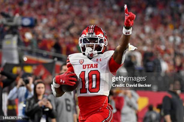 Money Parks of the Utah Utes celebrates as he scores a 57-yard touchdown against the USC Trojans during the third quarter in the Pac-12 Championship...