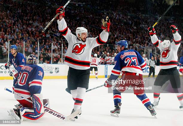 Travis Zajac of the New Jersey Devils celebrates a goal by teammate David Clarkson of the New Jersey Devils as Henrik Lundqvist of the New York...