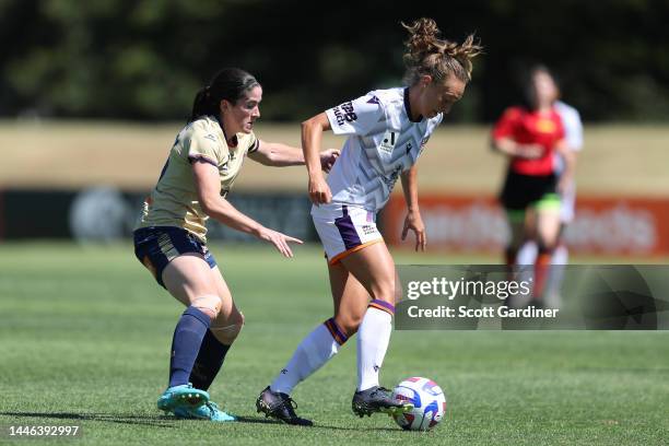 Elizabeth Anton of the Glory competes for the ball with Emily Garnier of the Jets during the round 3 A-League Women's match between Newcastle Jets...