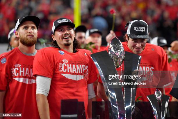 Cameron Rising of the Utah Utes celebrates in front of the Schwabacher Trophy after defeating the USC Trojans in the Pac-12 Championship at Allegiant...