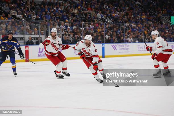 Jordan Staal and Jordan Martinook of the Carolina Hurricanes skate against the St. Louis Blues at Enterprise Center on December 1, 2022 in St Louis,...