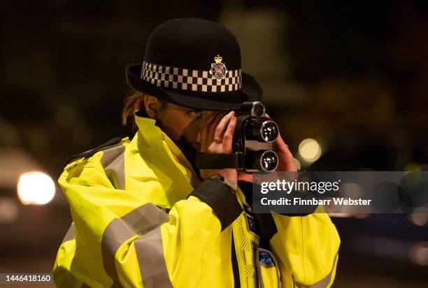 Police officer uses a speed gun to check drivers spee, on December 02, 2022 in Bournemouth, England. Dorset Police launched their annual...