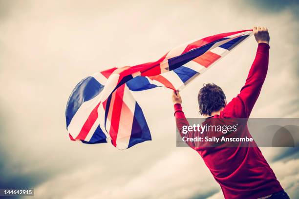 man waving union jack flag - holding flag stock pictures, royalty-free photos & images