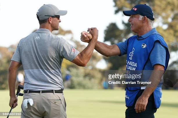 Adam Scott shakes hands with his caddie Steve Williams on the 18th green Day 3 of the 2022 ISPS HANDA Australian Open at Victoria Golf Club December...