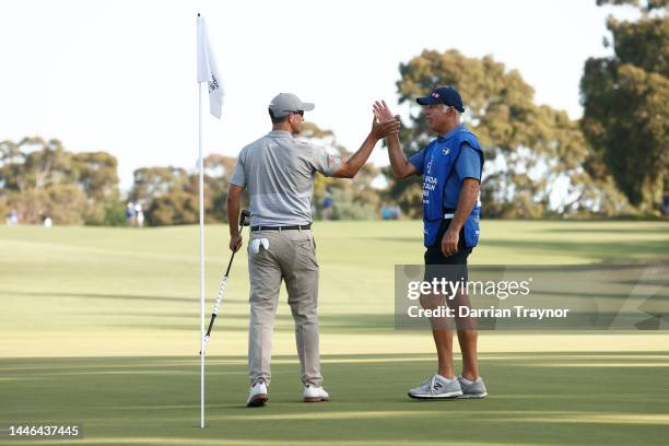 Adam Scott shakes hands with his caddie Steve Williams on the 18th green Day 3 of the 2022 ISPS HANDA Australian Open at Victoria Golf Club December...