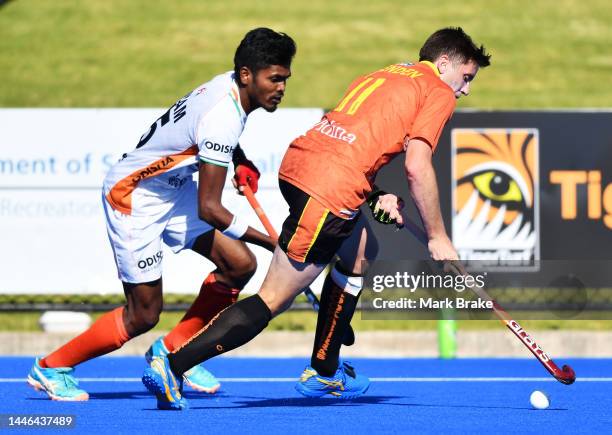 Eddie Ockenden captain of the Kookaburras competes with Sanjeep Nilan Xess during game 4 of the International Hockey Test Series between Australia...