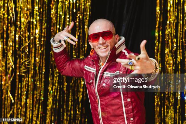 man on new year party, posing on sparkle decorations - emcee imagens e fotografias de stock