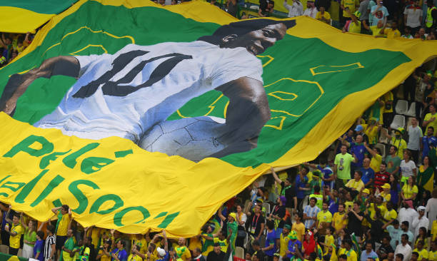 Flag of Brazil legend Pele is unveiled in the crowd ahead the FIFA World Cup Qatar 2022 Group G match between Cameroon and Brazil at Lusail Stadium...