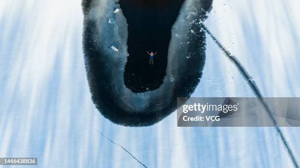 Aerial view of a winter swimmer swimming in a pool carved out of a frozen lake at Beiling Park on December 3, 2022 in Shenyang, Liaoning Province of...