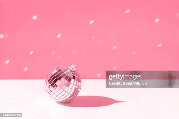 merry christmas and happy new year invitation. silver disco ball on  pastel red viva magenta color of the year 2023 background with snow. - disco ball bildbanksfoton och bilder