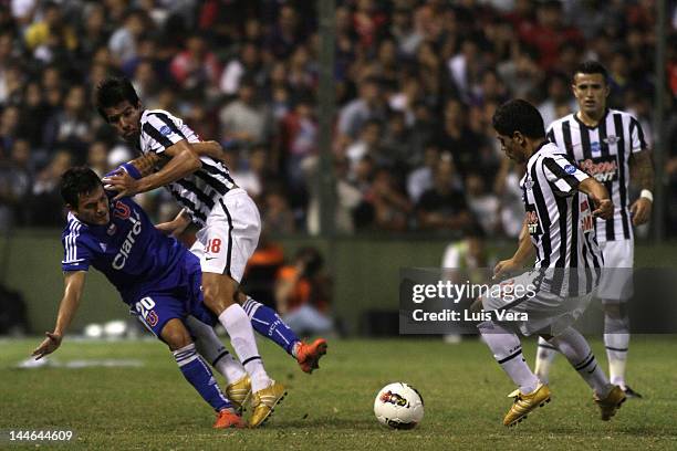 Charles Aranguiz of Universidad de Chile dispute the ball with Victor Caceres and Rodolfo Gamarra of Libertad, during a match between Libertad and...