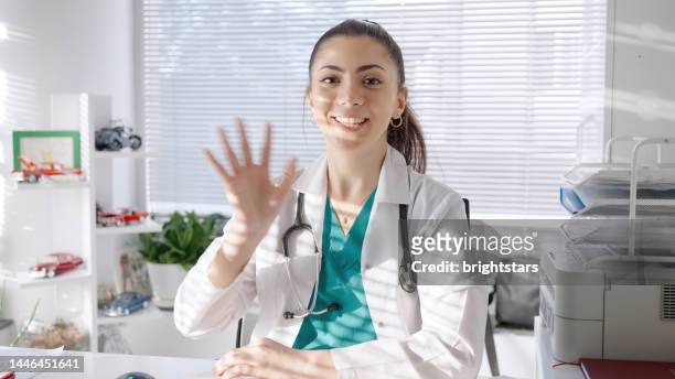 pov: young female doctor video conferencing - personal perspective doctor stock pictures, royalty-free photos & images