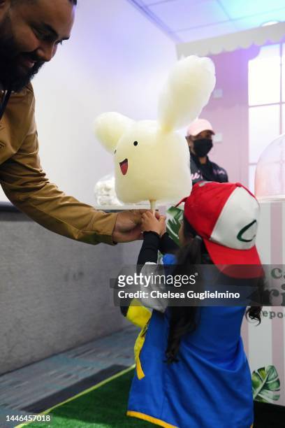 Attendees order Pikachu cotton candy at 2022 Los Angeles Comic Con at Los Angeles Convention Center on December 02, 2022 in Los Angeles, California.