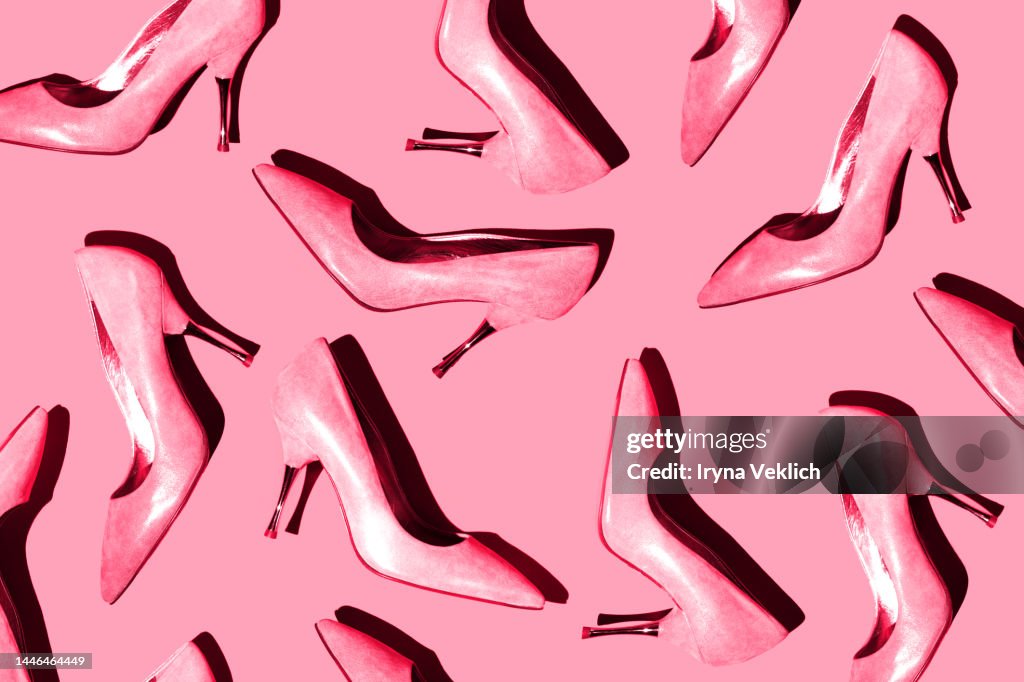 Fashion pattern with Woman's high-heeled shoes in pastel Color of the Year 2023 Viva Magenta on pink color background. Black Friday beauty modern concept.