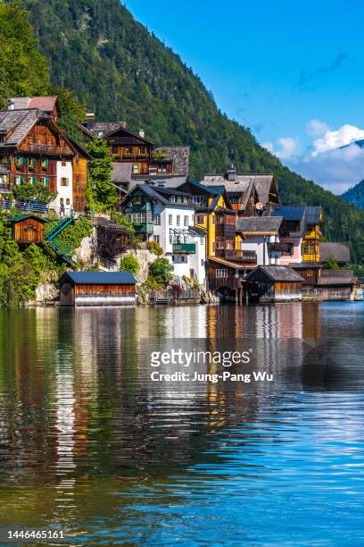 hallstatt village houses and reflection on hallstatter see lake in austria - gmunden austria stock pictures, royalty-free photos & images