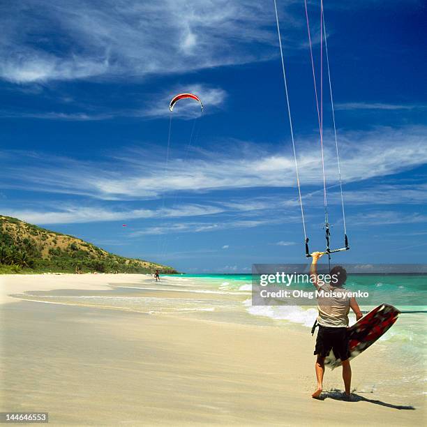 kitesurfer taking off on beach - kiteboarding caribbean stock pictures, royalty-free photos & images