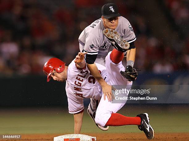 Second baseman Gordon Beckham of the Chicago White Sox and Peter Bourjos of the Los Angeles Angels of Anaheim collide as Beckham turns a double play...