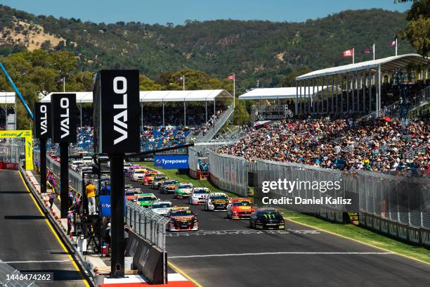 Scott Pye driver of the Seiko Racing Holden Commodore ZB and Cameron Waters driver of the Monster Energy Racing Ford Mustang lead at the start of...