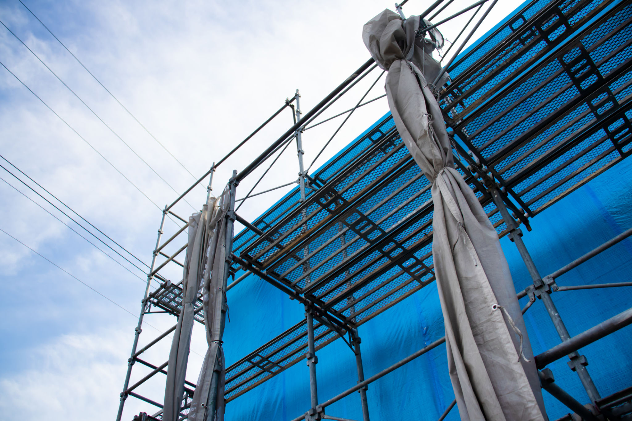 House under construction covered with blue tarp. House under construction covered with blue tarp.