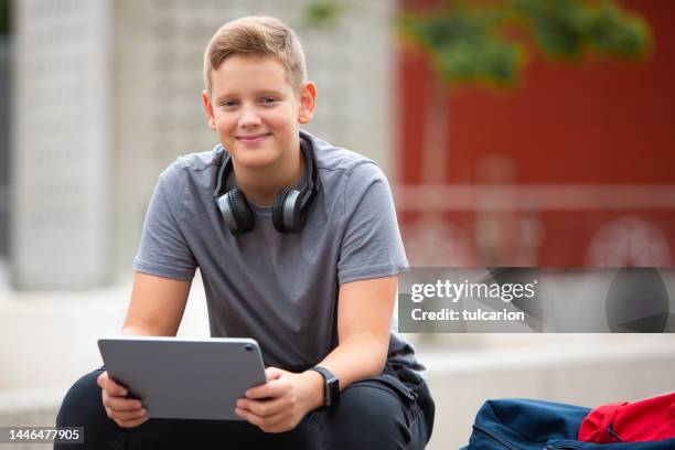 enjoying his online class - boy wearing backpack stock pictures, royalty-free photos & images