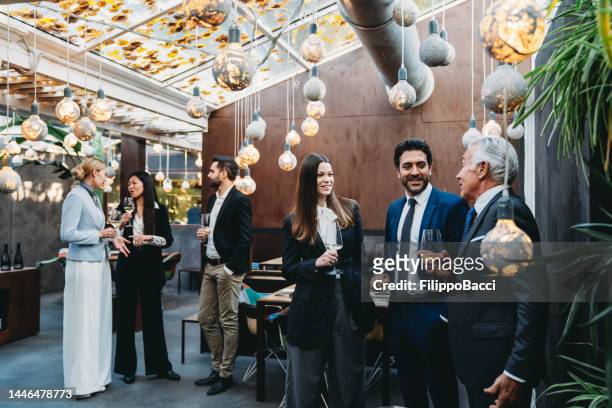 gli uomini d'affari parlano insieme durante un evento di team building in un ristorante di lusso - luxury hotel foto e immagini stock