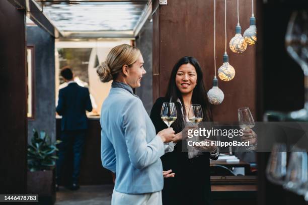 business people are talking together at the restaurant while drinking wine for the aperitif - chinese waiter stock pictures, royalty-free photos & images